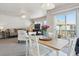 Inviting dining area with a table set for four, complemented by a bright living space and natural light at 12832 Mayfair Way # A, Englewood, CO 80112