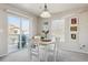 Bright dining area featuring a table set for four and a sliding glass door to a balcony at 12832 Mayfair Way # A, Englewood, CO 80112