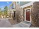 The entrance features a warm, inviting brown door and stone accents for a cozy and charming welcome at 12832 Mayfair Way # A, Englewood, CO 80112