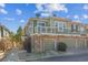 Inviting two-story townhome with a stone facade, balcony, and a private garage, offering comfort at 12832 Mayfair Way # A, Englewood, CO 80112