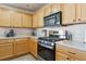 Well-equipped kitchen featuring stainless steel appliances, wood cabinets, and ample counter space at 12832 Mayfair Way # A, Englewood, CO 80112