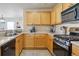 Kitchen featuring wood cabinets, counter space, and stainless steel appliances for a modern cooking space at 12832 Mayfair Way # A, Englewood, CO 80112