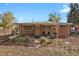 Backyard view of home with patio and landscaping at 3045 Xanadu St, Aurora, CO 80011