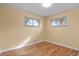 Simple bedroom with hardwood floors and two windows at 3045 Xanadu St, Aurora, CO 80011