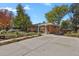 Ranch home with a large driveway and mature trees at 3045 Xanadu St, Aurora, CO 80011