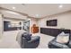 Finished basement with a wet bar, entertainment area, and plush seating for relaxing at 6005 Beeler St, Denver, CO 80238