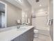 Modern bathroom features a spacious vanity, large mirror, and a shower-tub combo with white subway tile at 6005 Beeler St, Denver, CO 80238