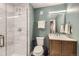 Stylish bathroom featuring a walk-in shower with glass door and a vanity with ample storage at 6005 Beeler St, Denver, CO 80238