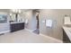 Bright bathroom featuring double sink vanity, and an adjacent walk-in closet at 6005 Beeler St, Denver, CO 80238