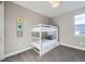 Light-filled bedroom with bunk beds and wall decor, offering a cozy space for  at 6005 Beeler St, Denver, CO 80238