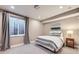 Tranquil bedroom with soft carpet, large window, and a bedside table with a lamp at 6005 Beeler St, Denver, CO 80238