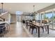 Bright dining room featuring wood table, modern chandelier, and seamless access to outdoor patio area at 6005 Beeler St, Denver, CO 80238