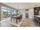 Inviting dining area with a wooden table, sliding glass doors to the backyard, and modern lighting at 6005 Beeler St, Denver, CO 80238