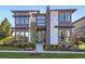 Modern two-story home featuring a combination of gray siding, white brick accents, and large windows at 6005 Beeler St, Denver, CO 80238