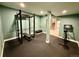 This home gym features black padded floors and weights at 6005 Beeler St, Denver, CO 80238