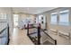 Bright hallway with hardwood floors leads to an open-concept play area, perfect for families at 6005 Beeler St, Denver, CO 80238