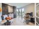 Contemporary home office with gray built-in cabinets, corner windows, and a sleek workspace with modern furniture at 6005 Beeler St, Denver, CO 80238