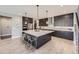 Elegant kitchen with a large center island, stainless steel appliances, and sleek cabinetry with a light backsplash at 6005 Beeler St, Denver, CO 80238