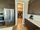 Modern kitchen with stainless steel refrigerator, built in oven, and a view into a spacious pantry at 6005 Beeler St, Denver, CO 80238