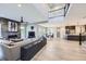 Expansive open-concept living room featuring fireplace, modern decor, and seamless flow to the dining and kitchen areas at 6005 Beeler St, Denver, CO 80238