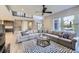 Spacious living room with a large sectional sofa, contemporary rug, and staircase to the upper level at 6005 Beeler St, Denver, CO 80238