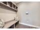 The mudroom features shelves, coat hooks and a bench at 6005 Beeler St, Denver, CO 80238