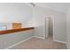 A carpeted bedroom with grey walls and a partial railing and partial wood wall at 14046 E Stanford Cir # I11, Aurora, CO 80015