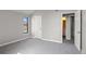 This is a bedroom with gray walls, carpet and white trim and a window view of the outdoors at 14046 E Stanford Cir # I11, Aurora, CO 80015
