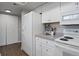 White kitchen with modern appliances and a large closet at 14046 E Stanford Cir # I11, Aurora, CO 80015