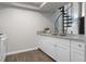 Kitchen featuring white cabinets, stainless steel sink, and spiral staircase at 14046 E Stanford Cir # I11, Aurora, CO 80015