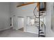 View of the living room and adjacent kitchen with a spiral staircase at 14046 E Stanford Cir # I11, Aurora, CO 80015