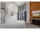 Inviting living room with a cozy fireplace, balcony, and modern spiral staircase at 14046 E Stanford Cir # I11, Aurora, CO 80015