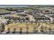 Stunning aerial view showcasing the neighborhood with green spaces and scenic lake views in the distance at 1421 Rustic Dr, Longmont, CO 80504