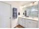 Bright bathroom features double vanity, well lit mirror, and soaking tub shower combo at 1421 Rustic Dr, Longmont, CO 80504