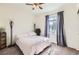 Comfortable bedroom featuring a pink comforter, ceiling fan, and a sunny window with light curtains at 1421 Rustic Dr, Longmont, CO 80504