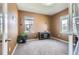 Inviting bedroom with neutral carpet, two bright windows, and a small entertainment center at 1421 Rustic Dr, Longmont, CO 80504