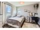 Charming bedroom featuring a window with natural light, soft textures, simple decor, and vinyl flooring at 1421 Rustic Dr, Longmont, CO 80504