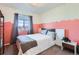 Cozy bedroom with unique paint design, a large window, neutral carpeting and minimalist furnishings at 1421 Rustic Dr, Longmont, CO 80504