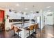 Bright kitchen with stainless appliances, center island with barstool seating, tile backsplash and ample white cabinetry at 1421 Rustic Dr, Longmont, CO 80504