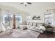 Spacious living room with large windows, comfortable seating, and neutral decor at 1421 Rustic Dr, Longmont, CO 80504