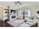 Bright living room with fireplace, hardwood floors, vaulted ceiling, and abundant natural light at 1421 Rustic Dr, Longmont, CO 80504