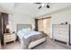 Main bedroom features a tray ceiling, soft neutral colors, ensuite bathroom with barn door, and ample closet space at 1421 Rustic Dr, Longmont, CO 80504