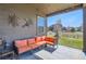 Relaxing covered patio with comfortable seating and a view of the well-maintained yard at 1421 Rustic Dr, Longmont, CO 80504