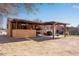 Spacious backyard featuring a covered patio area with a bar and plenty of room for outdoor activities at 5519 Tucson St, Denver, CO 80239