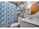 Charming bathroom with seashell shower curtain, vanity with sink and storage, and decor at 5519 Tucson St, Denver, CO 80239