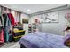 Cozy bedroom featuring a lilac bedspread and storage, offering a tranquil retreat at 5519 Tucson St, Denver, CO 80239