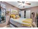 Cozy bedroom with bright yellow accents, soft textures, and ample natural light at 5519 Tucson St, Denver, CO 80239