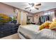 Comfortable bedroom featuring a black dresser, warm lighting, and charming decor at 5519 Tucson St, Denver, CO 80239