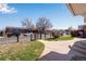 View of a landscaped front yard and a glimpse of the surrounding neighborhood at 5519 Tucson St, Denver, CO 80239