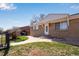 Well-maintained front yard with steps leading to a charming brick home and decorative door at 5519 Tucson St, Denver, CO 80239